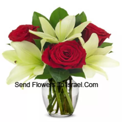 Red Roses And White Lilies With Seasonal Fillers In A Glass Vase