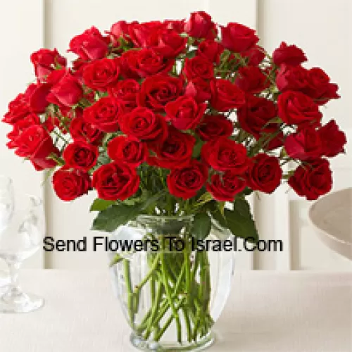 50 Red Roses With Some Ferns In A Glass Vase