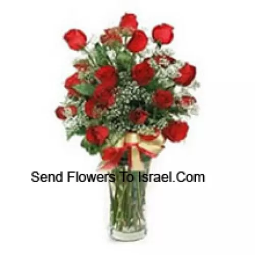 24 Red Roses With Some Seasonal Fillers In A Glass Vase