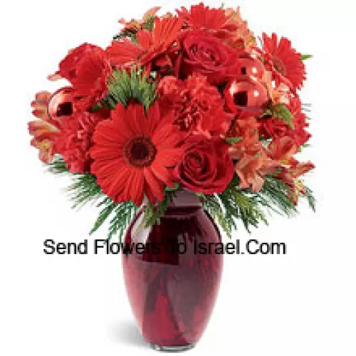 A beautiful holiday red glass vase holds an array of crimson blossoms. Carnations, roses, Gerbera daisies and alstroemeria are decorated with shiny red glass ornaments and interspersed with Christmas greens. Great to give, or to keep for yourself!? (Please Note That We Reserve The Right To Substitute Any Product With A Suitable Product Of Equal Value In Case Of Non-Availability Of A Certain Product)